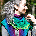 Chunky crescent-shaped lace shawl in rainbow yarn