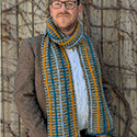 A unique conditional stitch pattern lays tubes of color down a garter stitch scarf