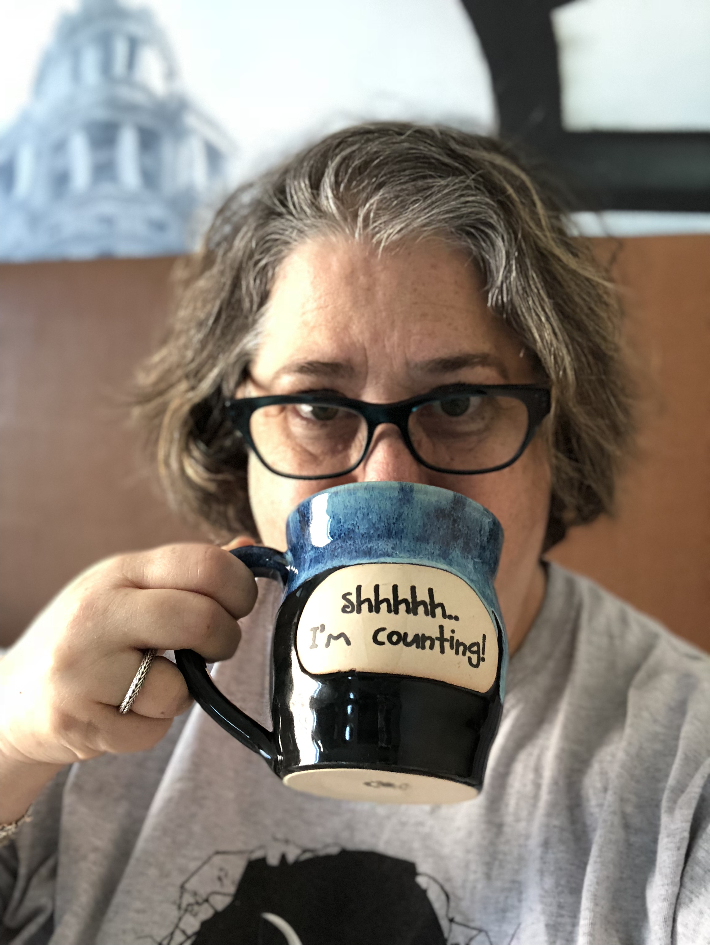 editor amy drinking out of a mug that says 'shhh, i'm counting'
