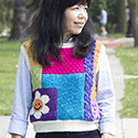 Scrappy vest in blocks of bright colors, each with a different stitch pattern