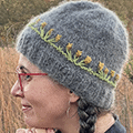 Sweet beanie with knit-in floral embellishment