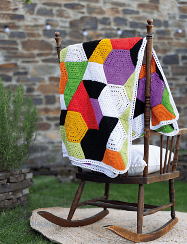 A page from Crochet Modular Blankets, featuring a blanket of hexagons where each half is a different color.