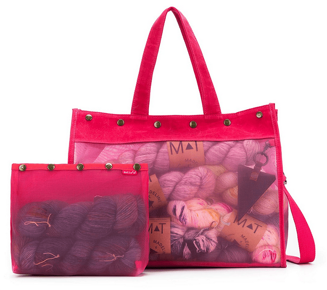 pink handbag with a snap closure, mesh sides, a scissor pocket inside on the right side, and a pouch inside on the left side.