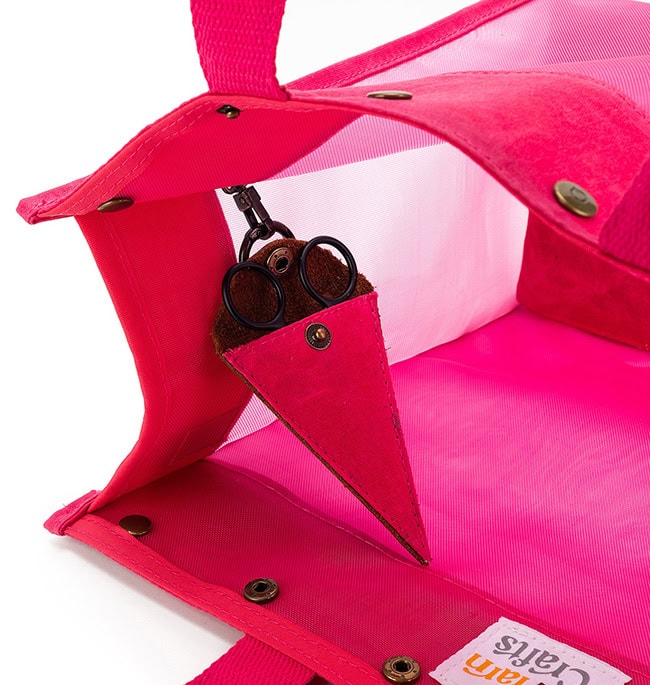 The inside of the bag, focused on the triangular scissor pocket for small scissors.