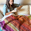 Weighted blanket worked in caramel stitch, designed to use a large quantity of random yarns