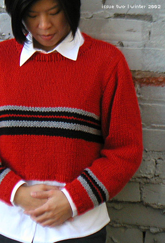 Very cropped long-sleeved crew-necked sweater with contrast stripes at the chest and sleeve ends. Fab!